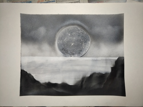 a white and black planet scape on poster board